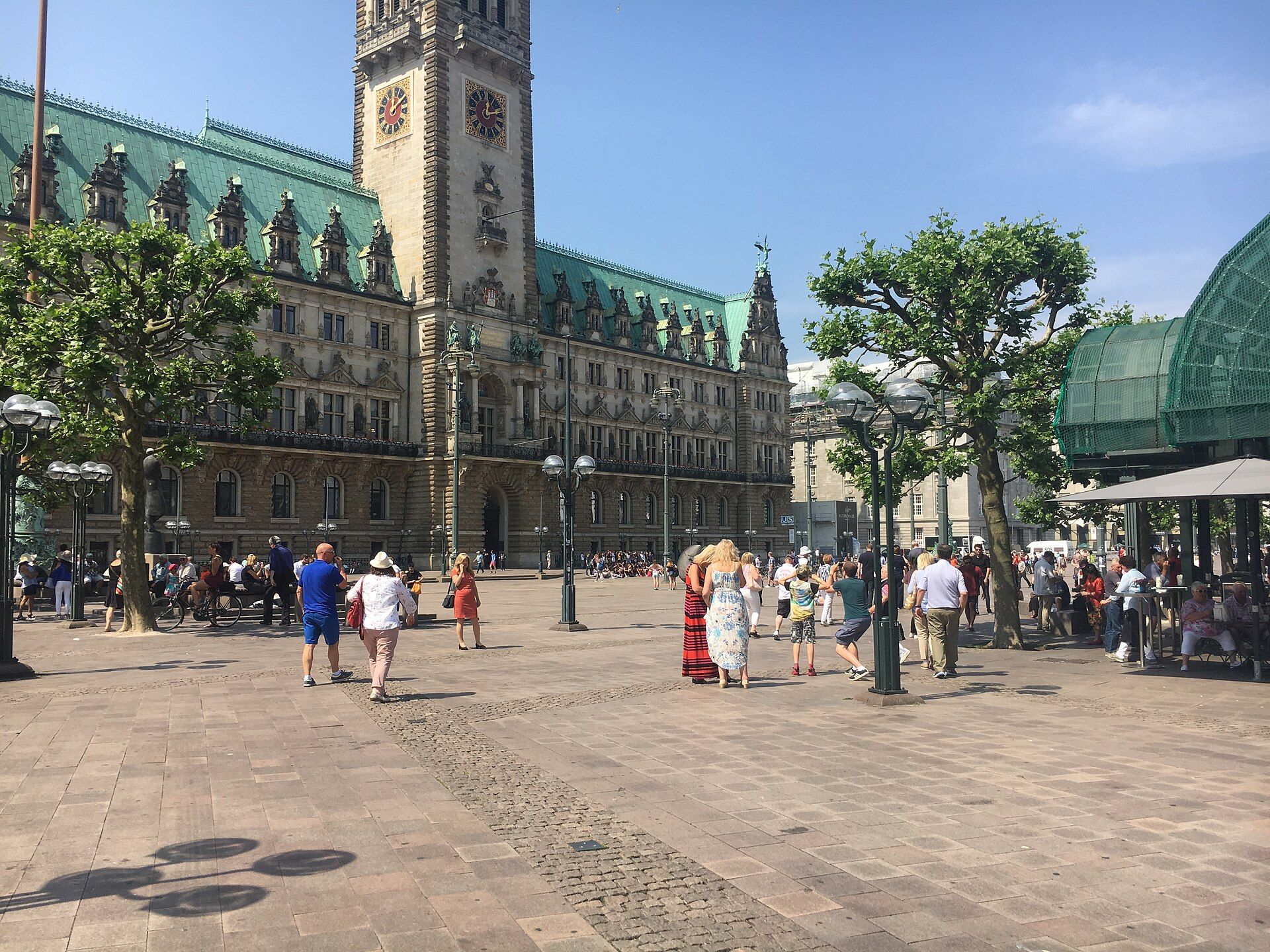 Hamburg City Hall seen across Rathausmarkt, with its clock tower and green copper roofs.