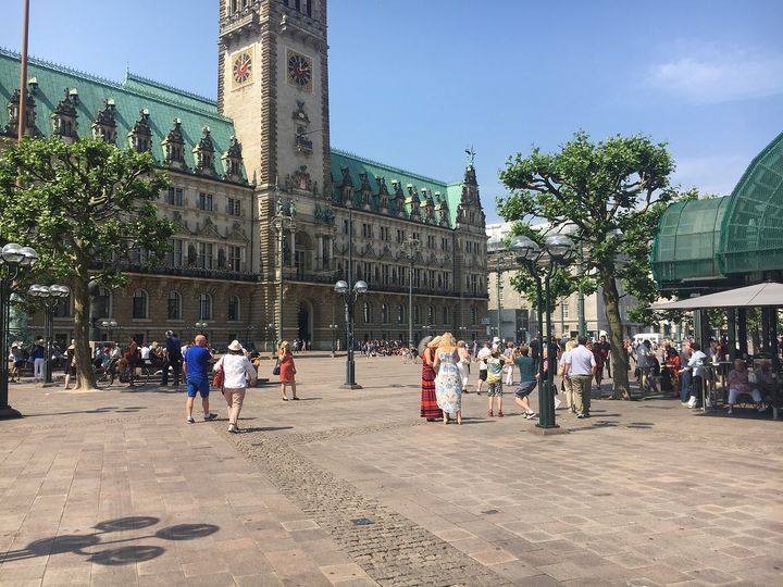 Hamburg City Hall seen across Rathausmarkt, with its clock tower and green copper roofs.